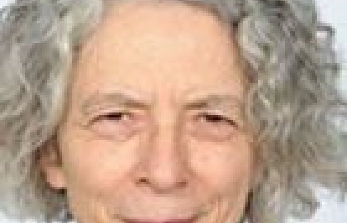 Lynn’s face: short grey hair, white skin, slim face